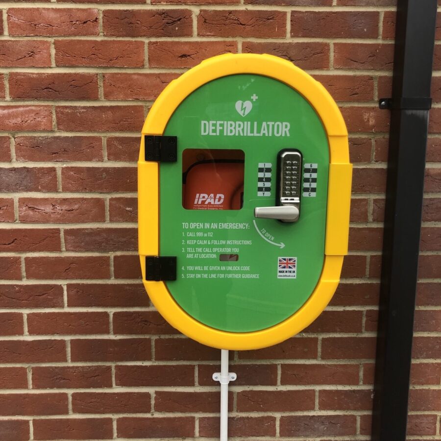 Bright green and yellow defibrillator unit