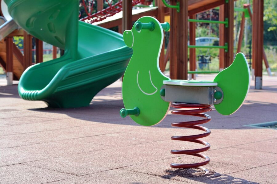 A bright green spring rider shaped like a duck