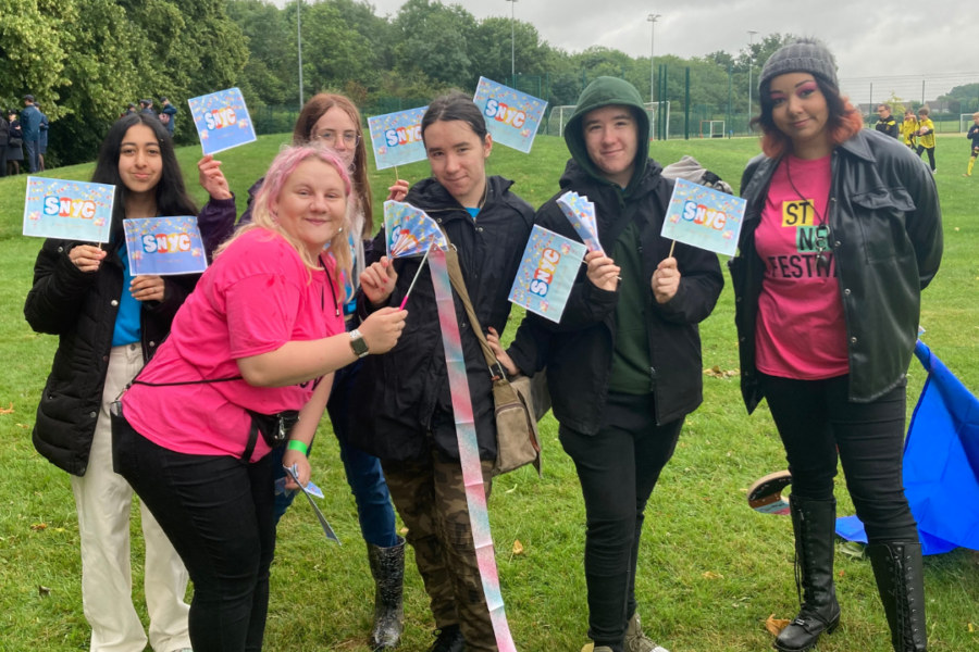 A group of young people standing outdoors