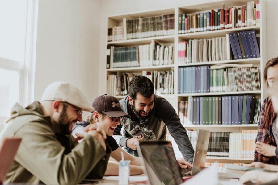 A group of students collaborates around a table